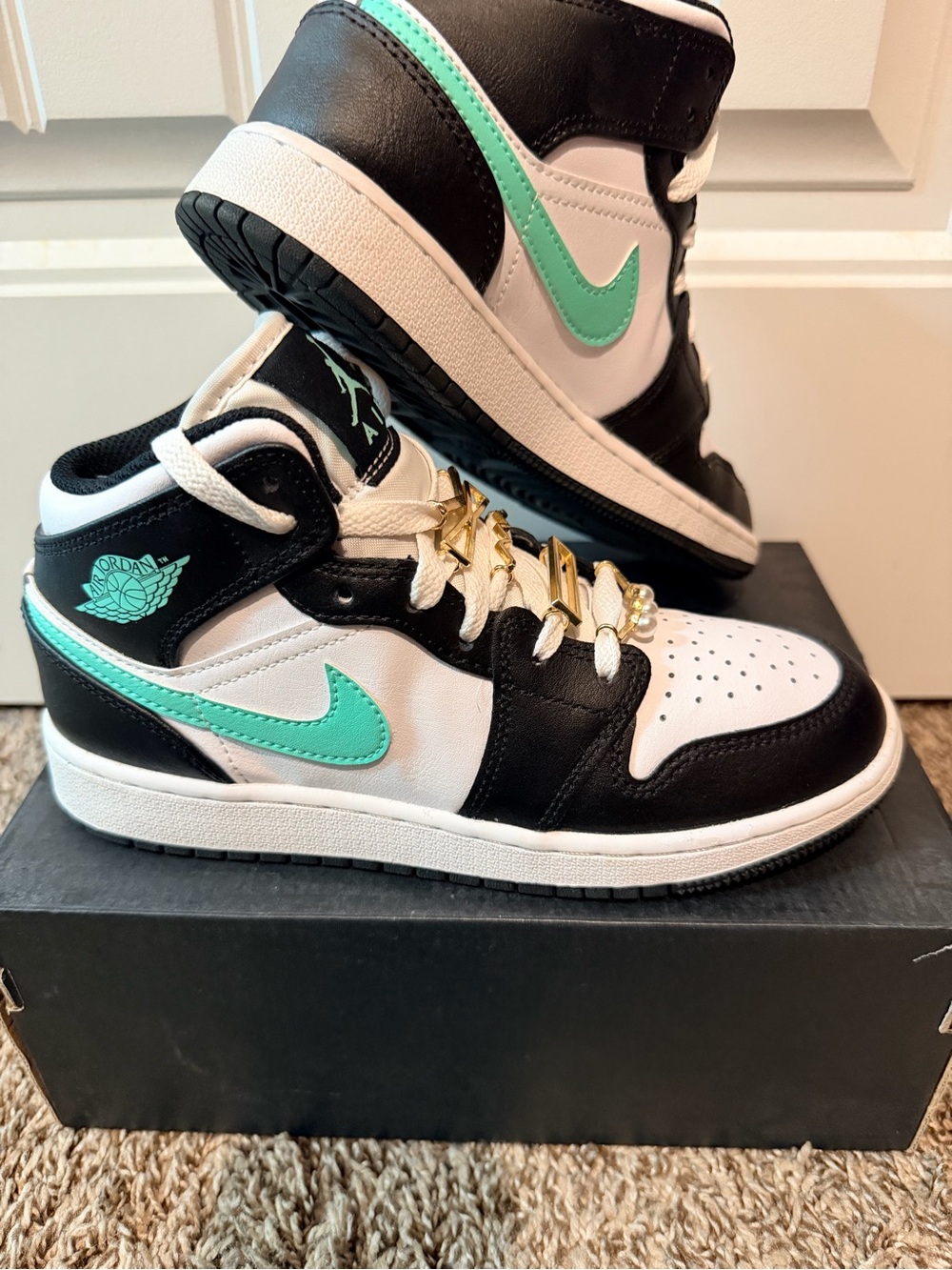 Jordan 1 Mid Top Sneakers in Black, White & Mint